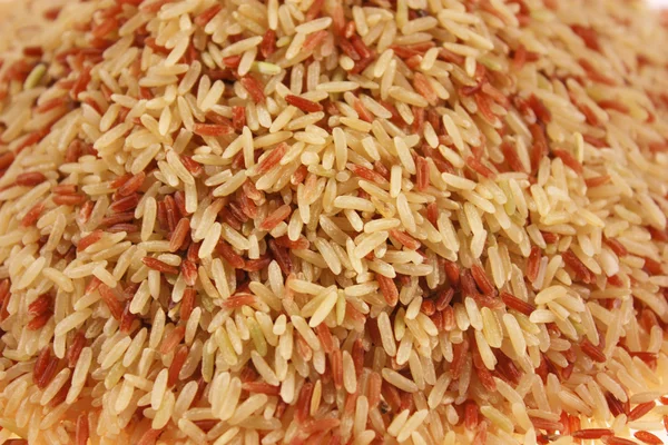 Brown rice grains background — Stock Photo, Image
