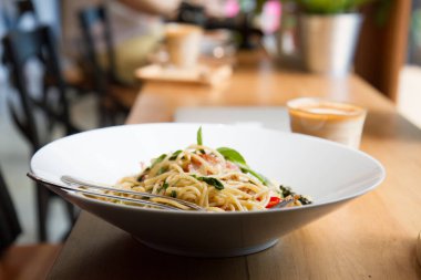 Pastırmalı spagetti, maydanoz ve parmesan peyniri taze biber, fesleğen yaprağı. Beyaz tabakta Carbonara makarnası. İtalyan gıda konsepti.