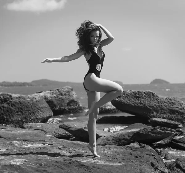 Spiaggia di pietra.Foto in bianco e nero della ragazza in costume da bagno — Foto Stock