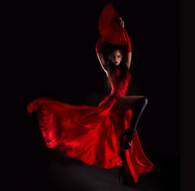 Woman in long red dress posing in studio clipart