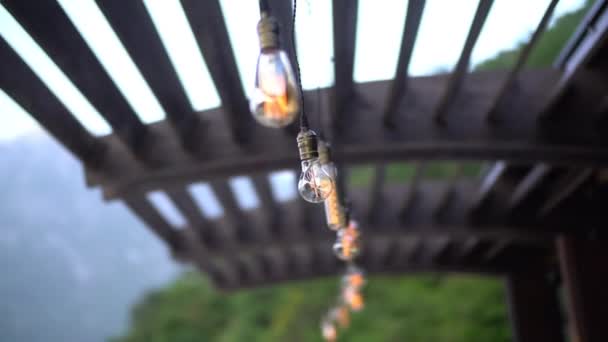 Wooden canopy with decorative light bulbs closeup — Stock Video