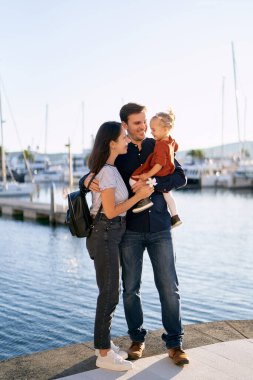 Aile deniz kıyısındaki bir rıhtımda hafta sonunun tadını çıkarıyor.
