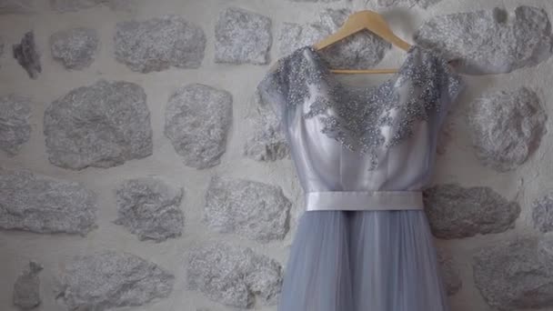 Delicate brides dress hanging on the wall with decorative stone — Stock Video