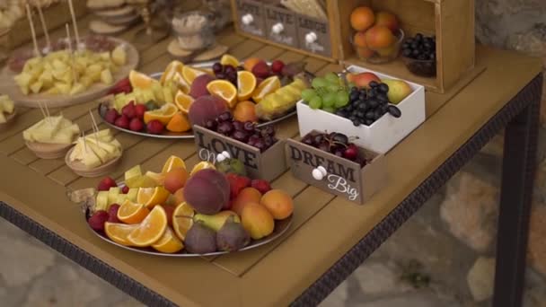 Bufê de casamento com lanches de frutas em uma mesa de madeira — Vídeo de Stock