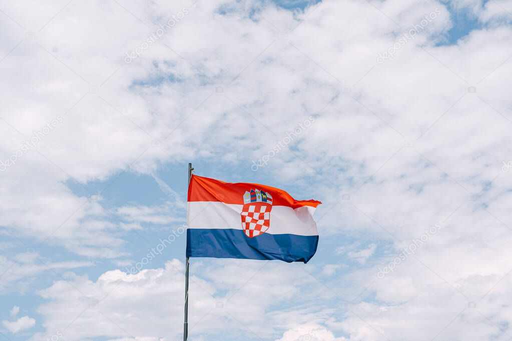 Croatian flag waving in the wind against the sky.