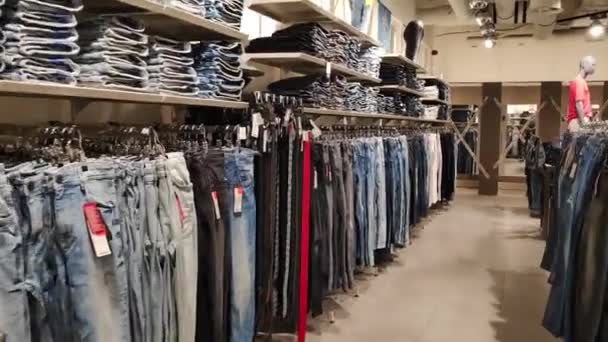 Budva, Monténégro - 01 août 2020 : Jeans dans le magasin. Les marchandises sont sur les étagères. Boutique de mode élégante. — Video