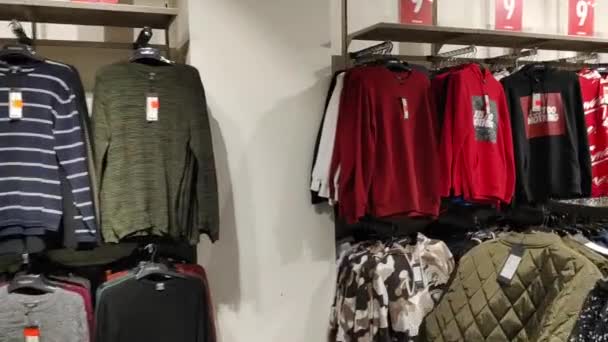 Budva, Montenegro - 01 august 2020: Kameraet flyver over hylderne med varerne i tøjbutikken. NewYorker butik interiør. – Stock-video