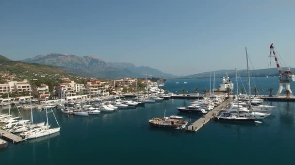 View of the Porto Montenegro marina in Tivat, yachts at the pier, crane and hotel complex — Stock Video