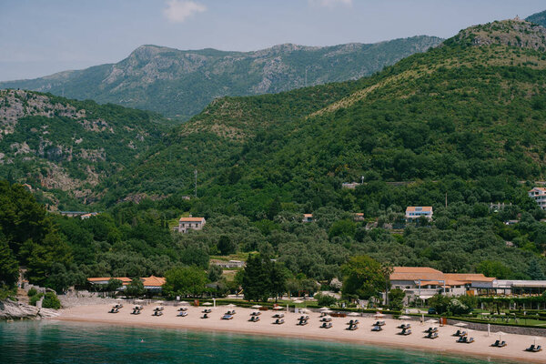 Sun loungers sit on the sand of the Royal Beach in Przno. View from above