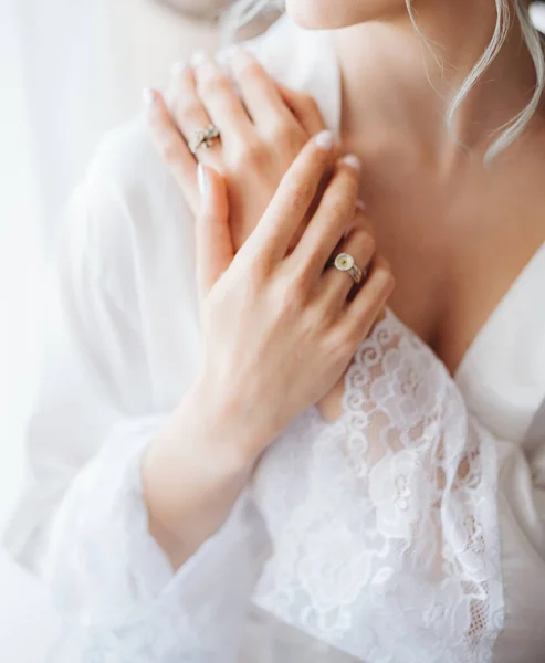 La novia con la túnica blanca dobló sus brazos sobre su pecho. Preparaciones para bodas — Foto de Stock