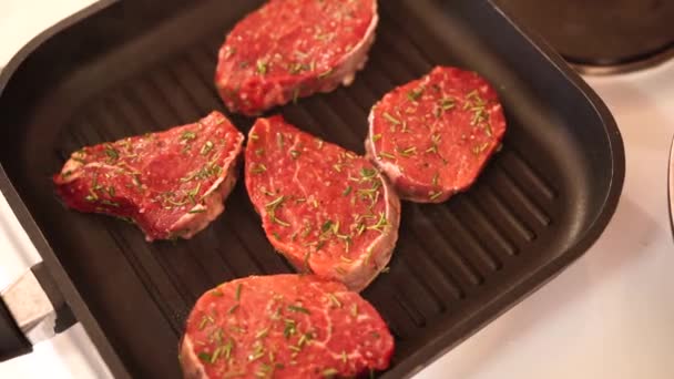 Krásné syrové kousky hovězího steaku v oleji a rozmarýnu. — Stock video