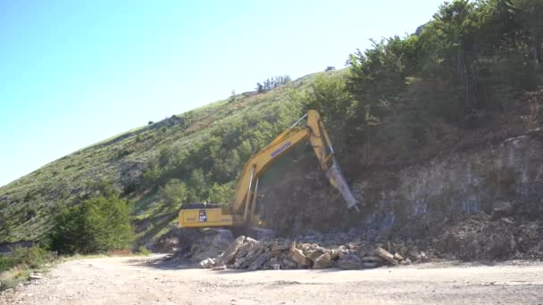 掘削機は山の石側を動作します — ストック動画