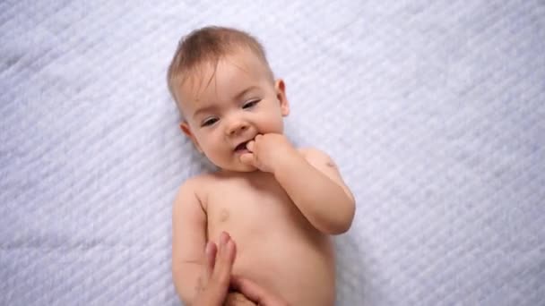 Moeder massages de baby schouders en armen — Stockvideo