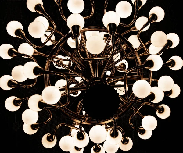 Abstract angle of hanging light fixture with brass hardware and light bulbs