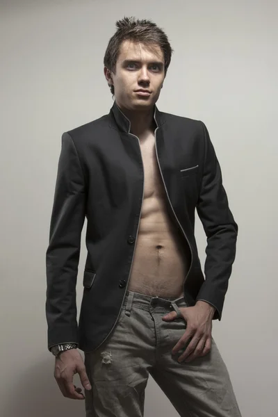 Young good-looking model  in dark suite  with naked torso — Stock Photo, Image