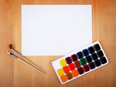 Watercolor paints with artistic brushes