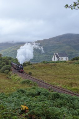 The Jacobite steam travells through Scottish Highland clipart