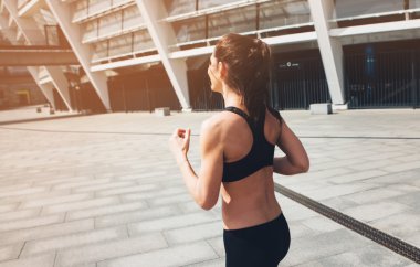 Spor kadın. Koşucu. Şehir üzerinde çalışan 