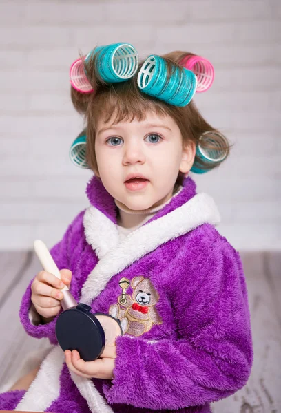 Child with curlers in bathrobe — Stock Photo, Image