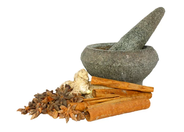 Ginger, cinnamon and star anise with stone pounder isolated on white — Stock Photo, Image