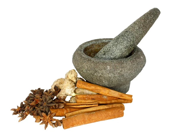 Ginger, cinnamon and star anise with stone pounder isolated on white — Stock Photo, Image