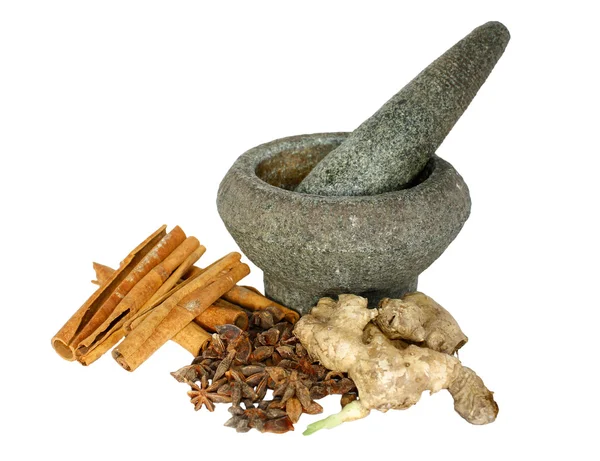 Ginger, cinnamon and star anise with stone pounder isolated on white — Stock Photo, Image