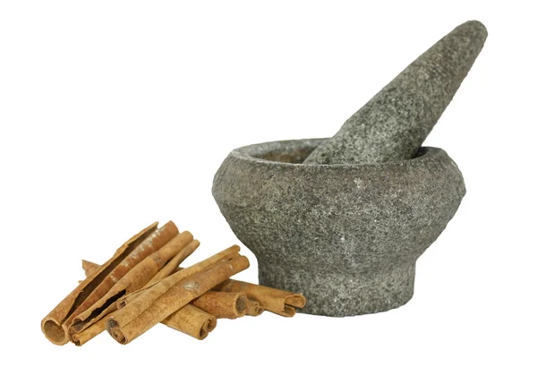 Cinnamon with stone pounder isolated on white — Stock Photo, Image