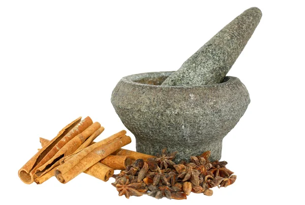 Cinnamon and star anise with stone pounder isolated on white — Stock Photo, Image