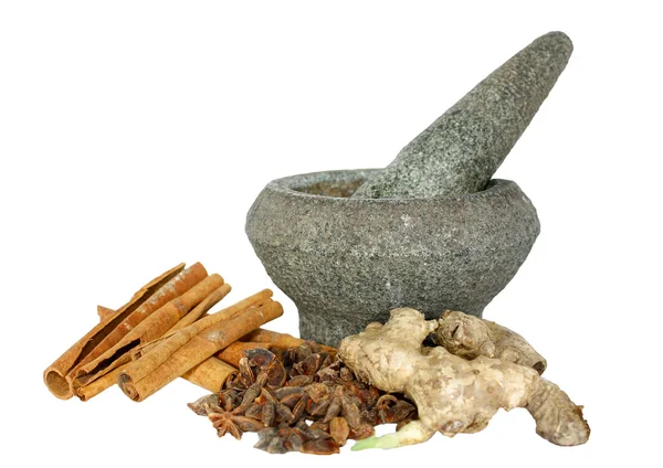 Ginger, cinnamon and star anise with stone pounder isolated on white — Stock Photo, Image