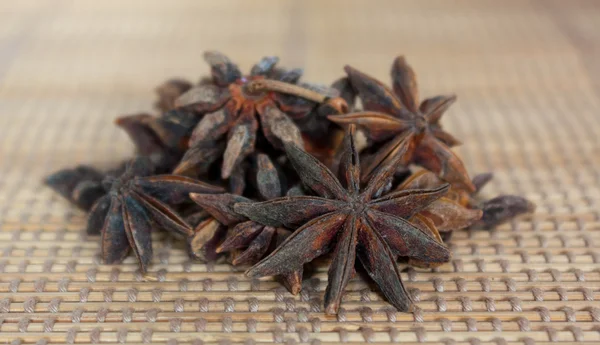 Star anise on straw mat — Stock Photo, Image