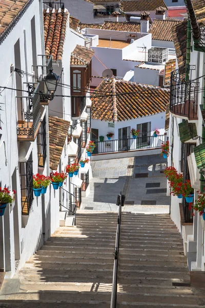 Picturesque street of Mijas with flower pots in facades. Andalus — Stock Photo, Image