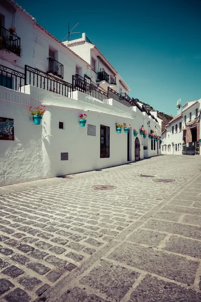 Picturesque street of Mijas with flower pots in facades. Andalus — Stock Photo, Image