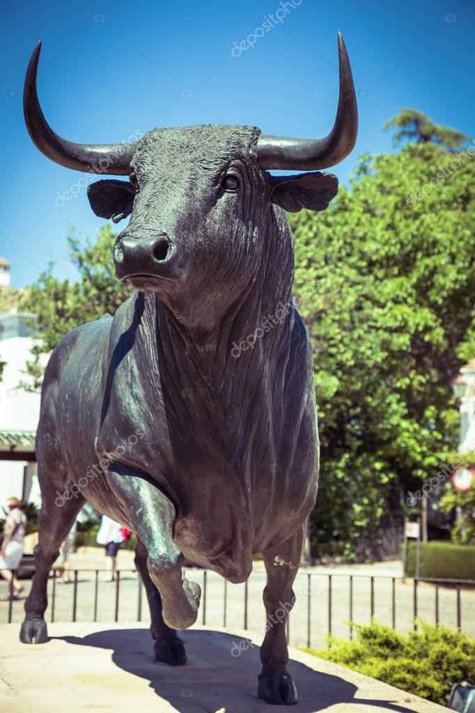 Bull statue in front of the bullfighting arena in Ronda, Spain Stock