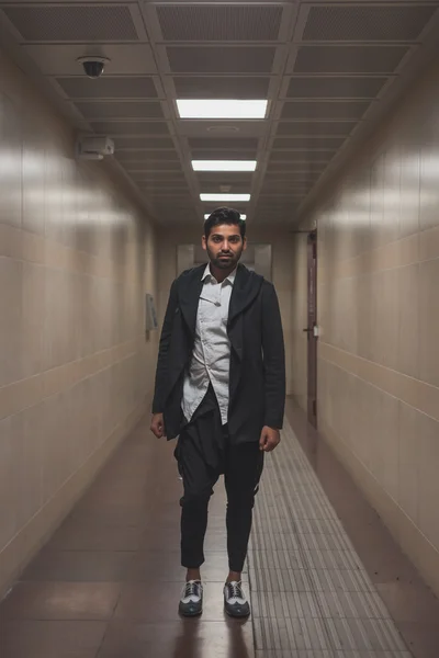 Handsome Indian man posing in a metro station — Stock Photo, Image