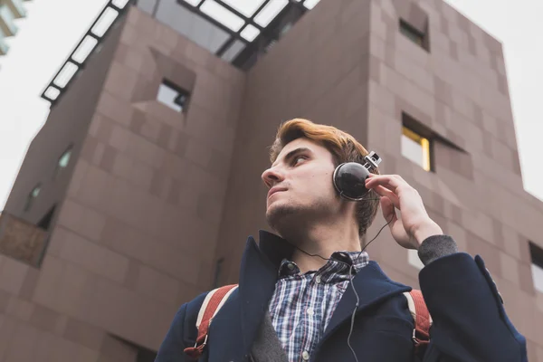 Young man listening to music in the city streets — Stock Photo, Image