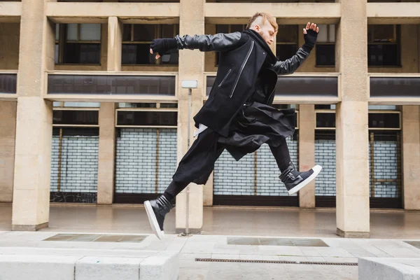 Stylish bearded man jumping in the street — Stock Photo, Image