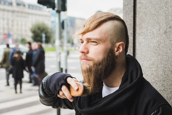 Stylish man brushing his beard — Stock Photo, Image