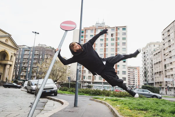 Stylish bearded man jumping in the street — Stock Photo, Image