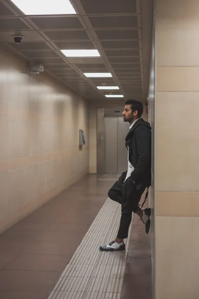 Handsome Indian man posing in a metro station — Stock Photo, Image