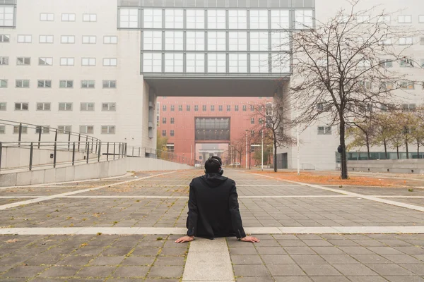 Beau Indien écoutant de la musique dans un contexte urbain — Photo