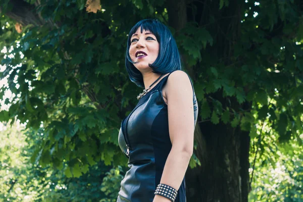 Pretty goth girl posing in a city park — Stock Photo, Image