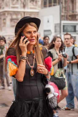 Woman outside Marco De Vincenzo fashion shows building for Milan Women's Fashion Week 2014 clipart