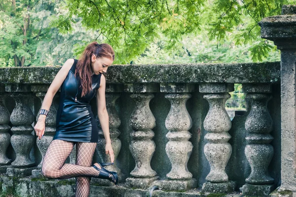 Pretty goth girl posing in a city park — Stock Photo, Image