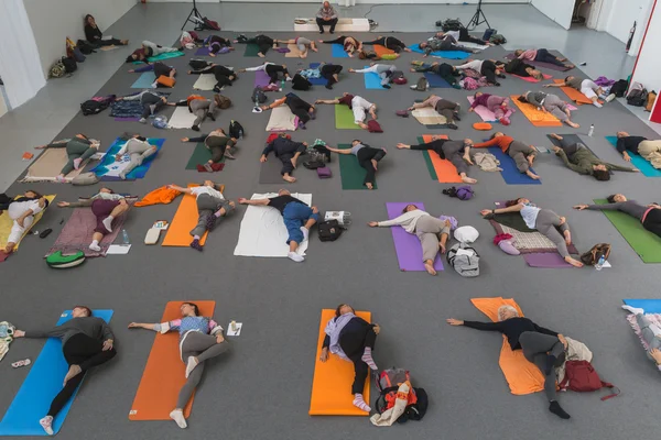 People take a class at Yoga Festival 2014 in Milan, Italy