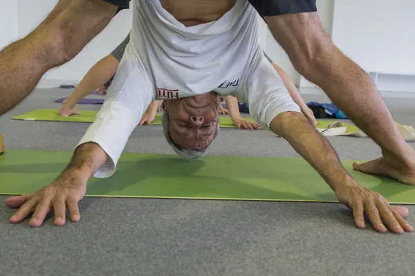 Man takes a class at Yoga Festival 2014 in Milan, Italy