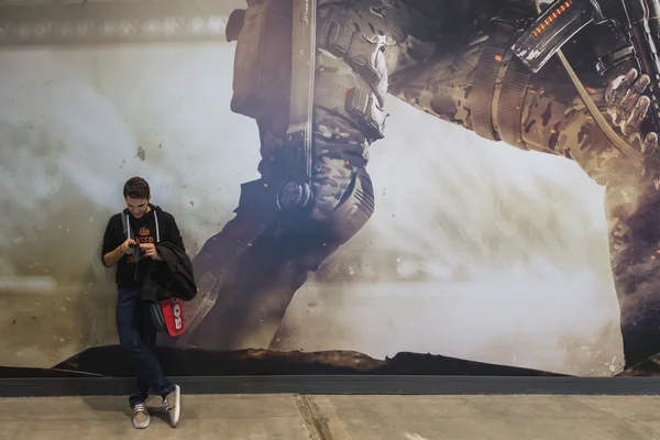 Guy texting at Games Week 2014 in Milan, Italy