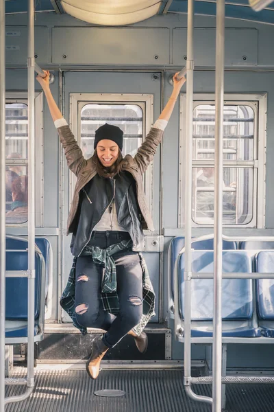 Pretty girl posing in a metro car — Stock Photo, Image