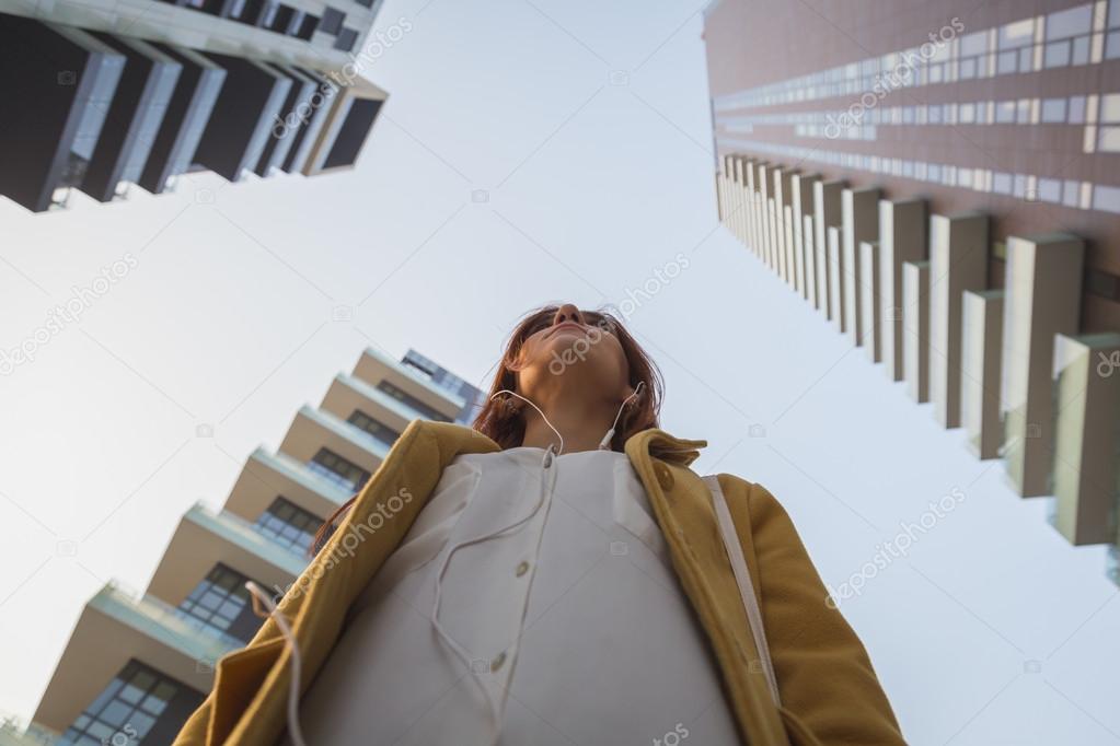 Redhead girl posing in the city streets