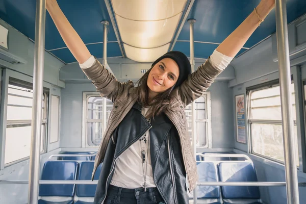 Pretty girl posing in a metro car — Stock Photo, Image