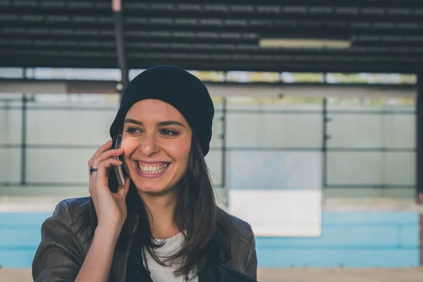 Красивая девушка разговаривает по телефону на станции метро — стоковое фото